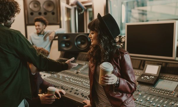 group of young musicians spending time at recording studio